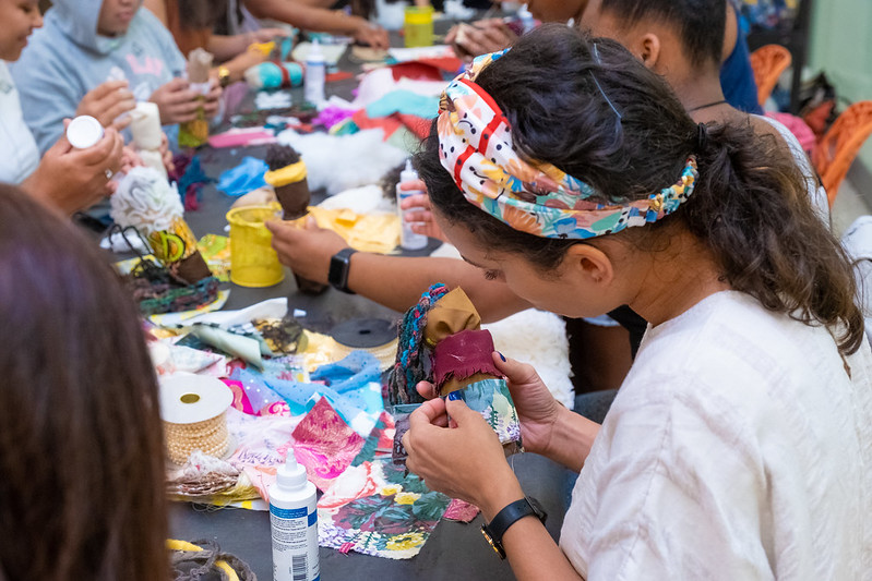 A young girl makes art at a table.